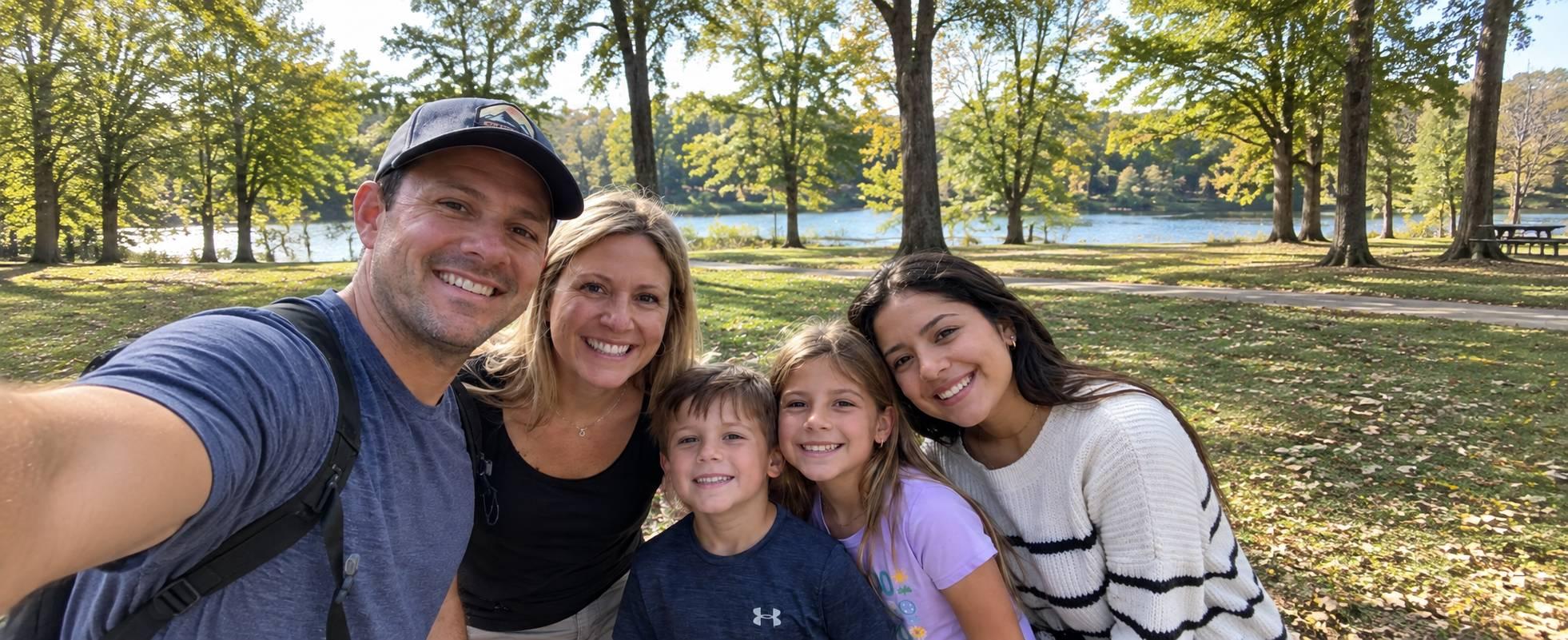 A family posing outdoors with a young south american girl